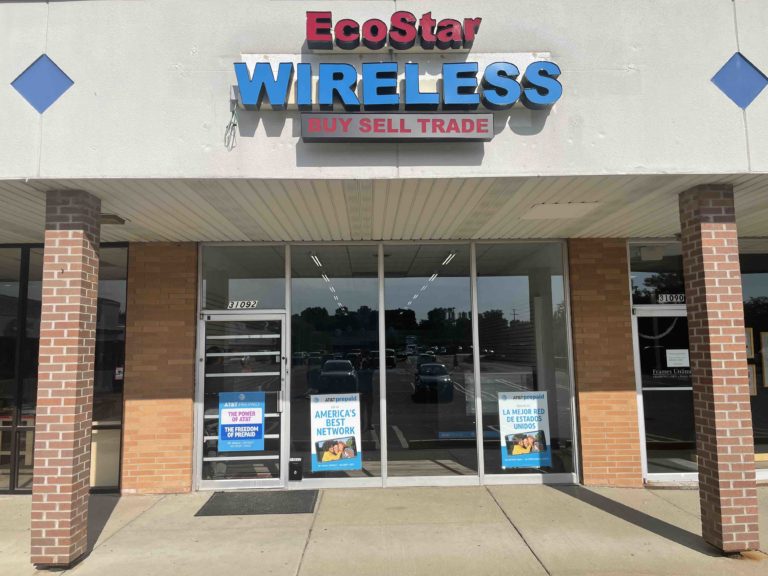 Front view of EcoStar Wireless store, showing its sign and entrance with promotional banners on the door.