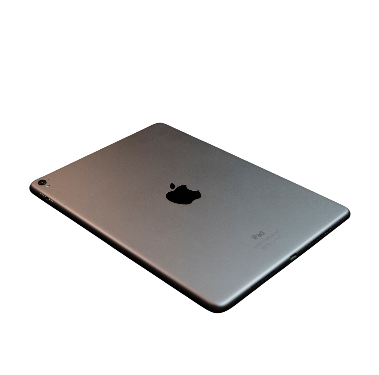 Silver iPad with Apple logo on a dark background.